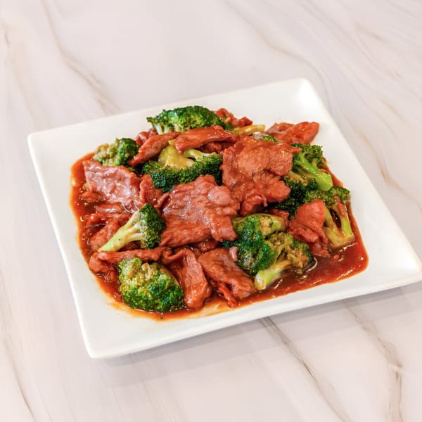 Golden China Restaurant's beef and broccoli stir-fry in a rich brown sauce on a white plate.