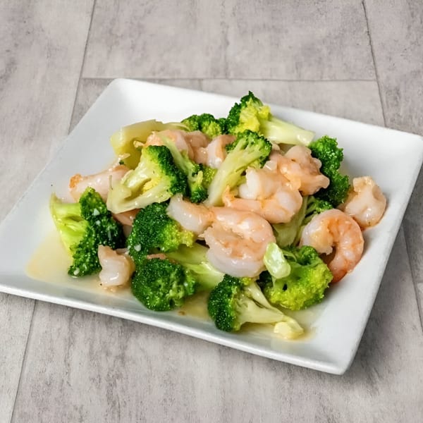 Golden China Restaurant's shrimp with broccoli, glistening with sauce, on a white rectangular plate.