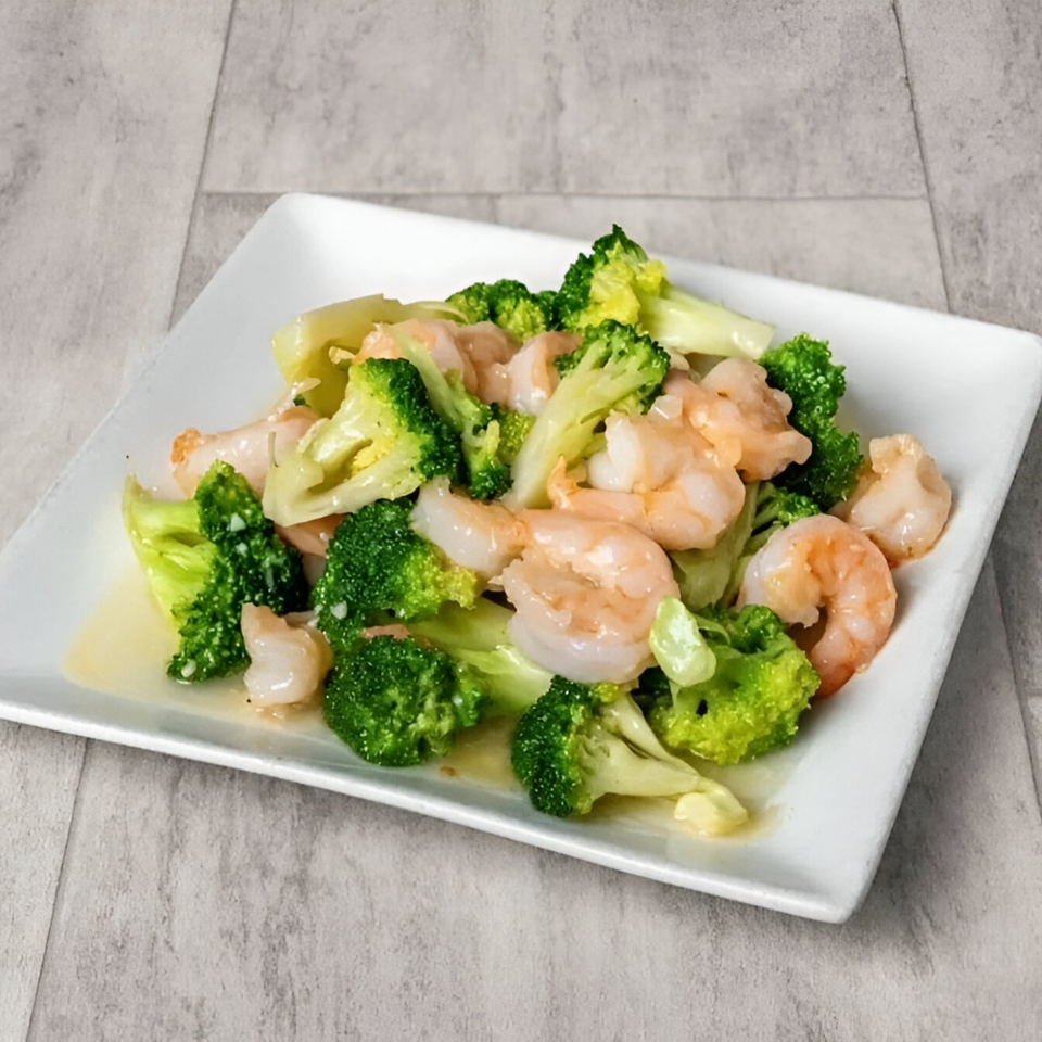 Golden China Restaurant's shrimp with broccoli, glistening with sauce, on a white rectangular plate.